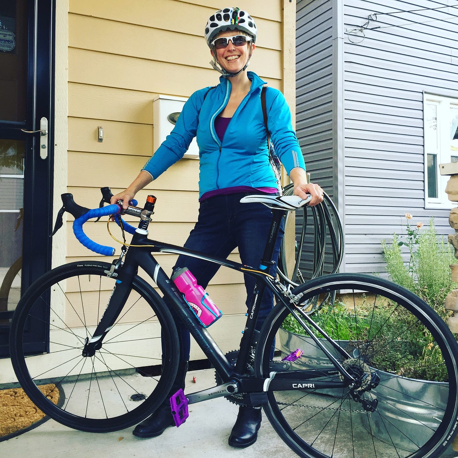 Jessie matchy-matchy in black and blue with her black and blue road bike