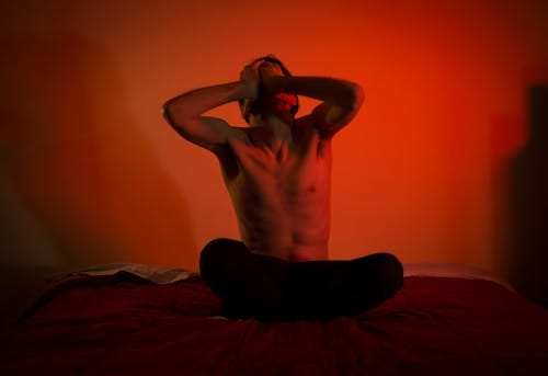 Free Topless Man Sitting on the Bed Stock Photo