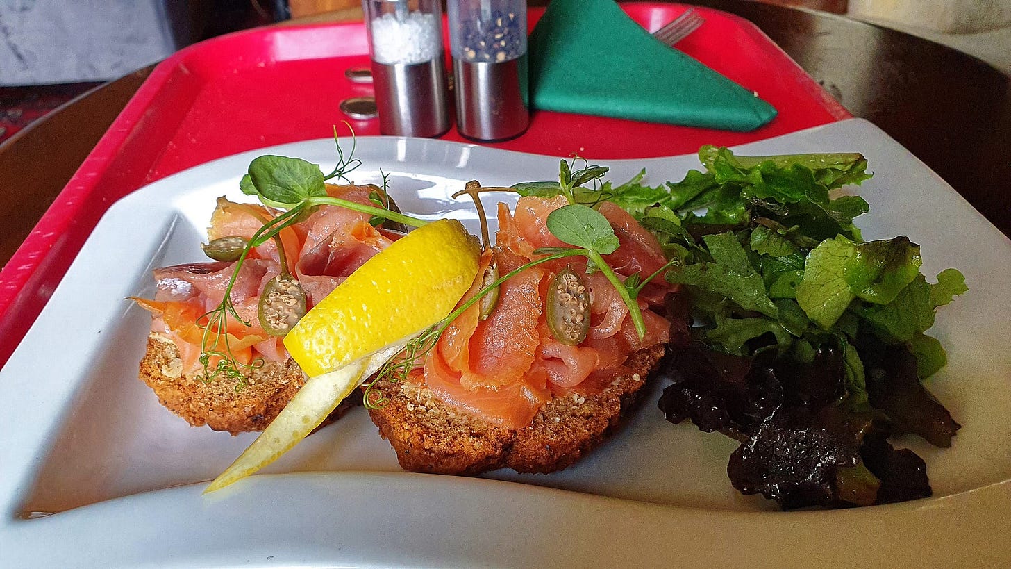 A delicious open-faced salmon sandwich on whole wheat bread