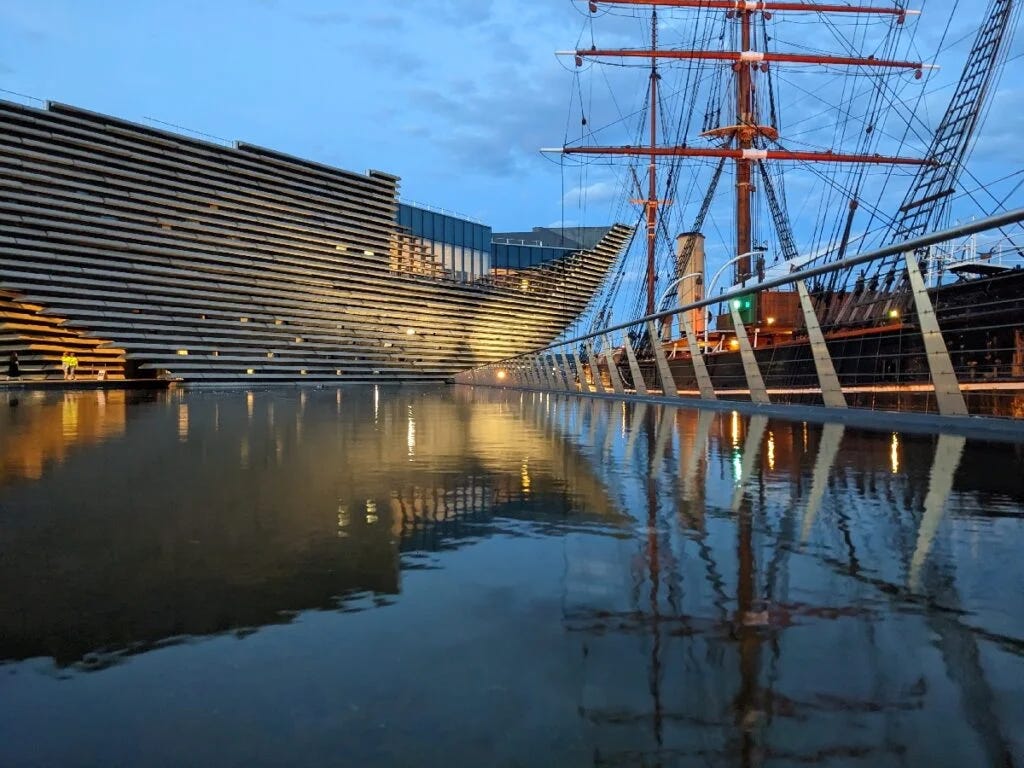 The V&A gallery in Dundee, seen across a pool at night