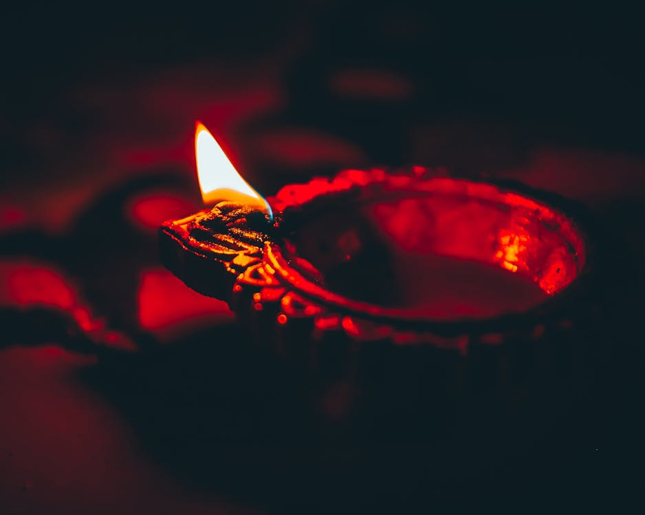 Free Close-up of a glowing diya lamp in dim lighting, symbolizing traditional Indian culture. Stock Photo Free Close-up of a glowing diya lamp in dim lighting, symbolizing traditional Indian culture. Stock Photo