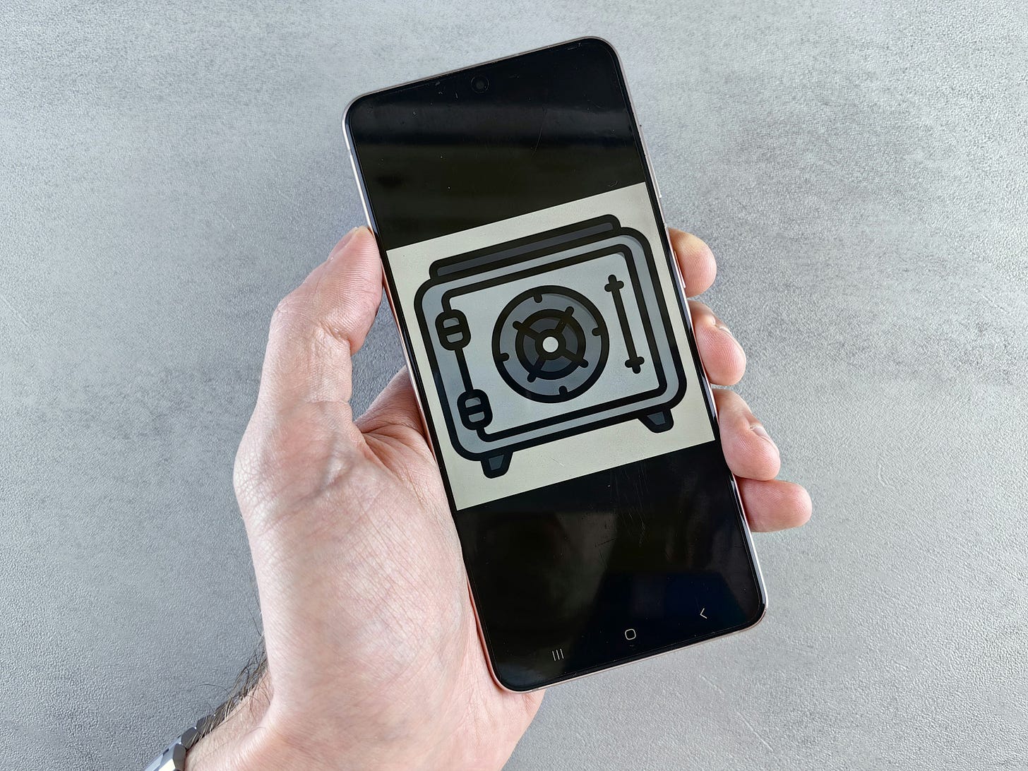 A photo of a person holding a cell phone with a clip art picture of a camera on it.