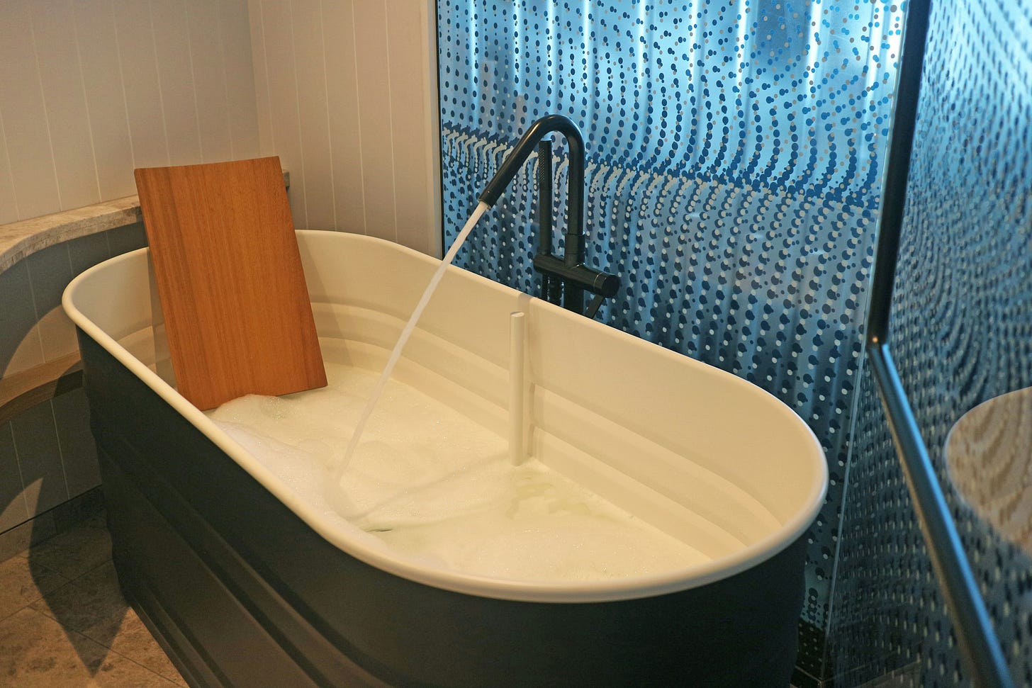 vintage style bathtub being filled with hot water