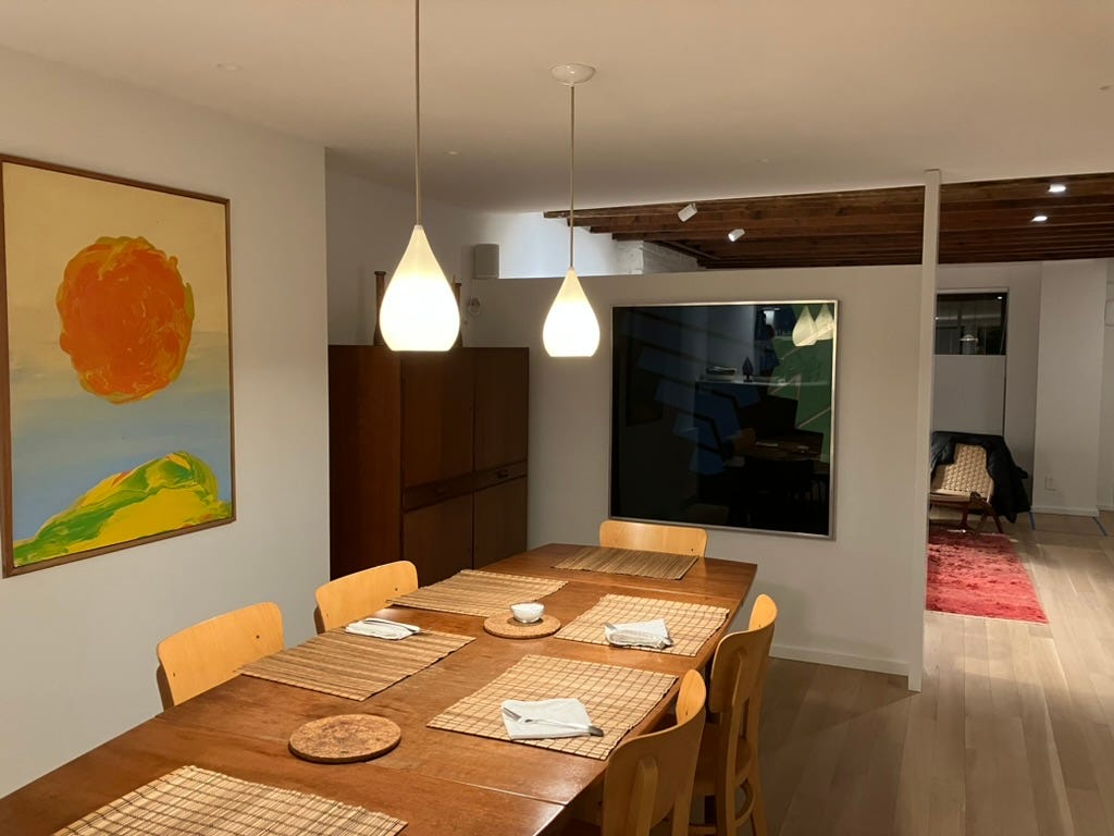 dining room set with table, pendant lights, and two works of art by my father