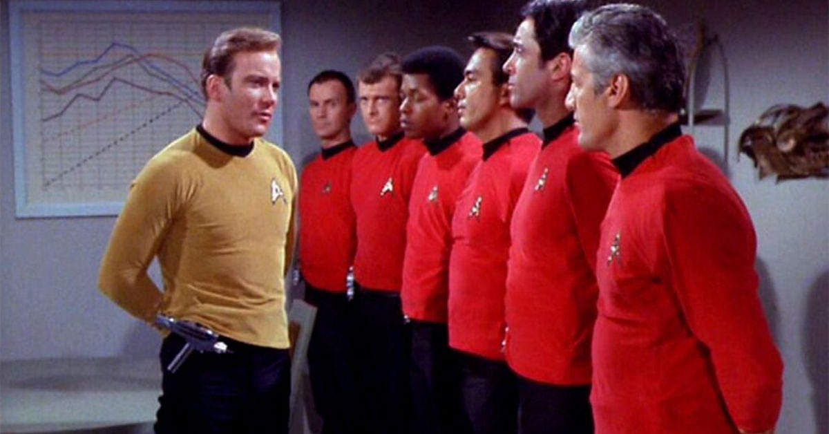 Photograph of Start trek the Original Series with Captain Kirk talking to a line of men in red shirts