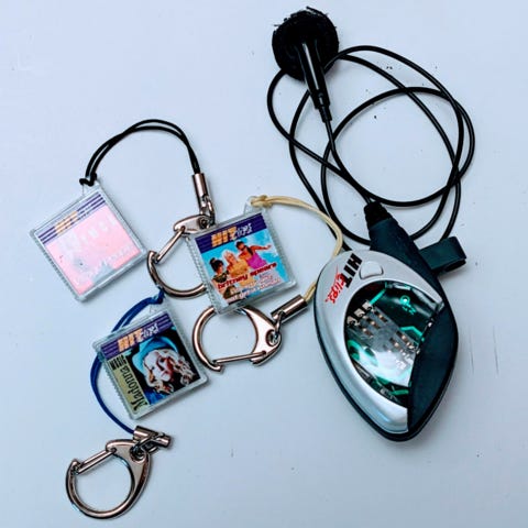 HitClips player with headphone, plus 3 music chips: Madonna "Music", Village People "YMCA", and Britney Spears "Not a Girl, Not Yet a Woman". 