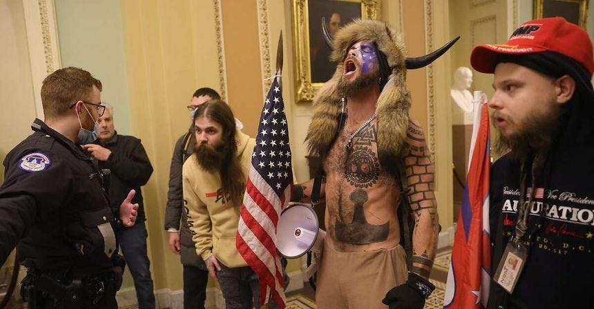 Jake Angeli, who calls himself the Q Shaman, seen inside the Capitol building on Wednesday.