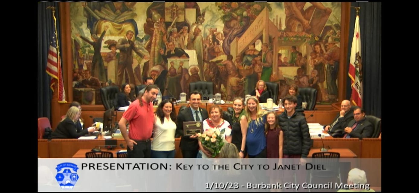 May be an image of 3 people, people standing and text that says 'PRESENTATION: KEY TO THE CITY TO JANET 1/10/23 -Burbank City Council Meeting'