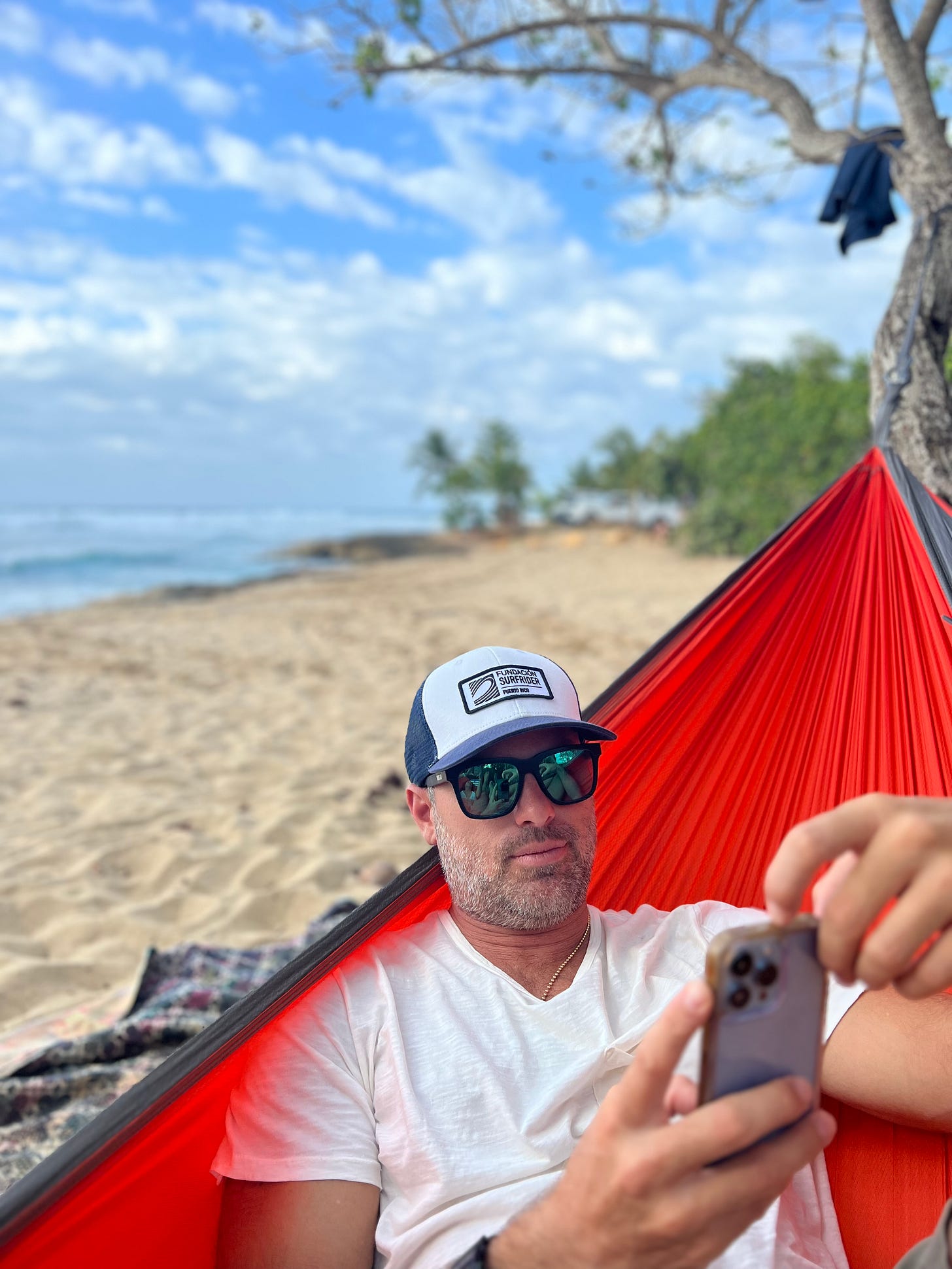 Nat Sharratt working on this newsletter from his beach hammock office
