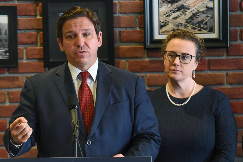 Florida Gov. Ron DeSantis (center) speaks alongside Rep. Erin Grall during a news conference at 2nd Street Bistro on Tuesday, Aug. 30, 202, in downtown Fort Pierce.