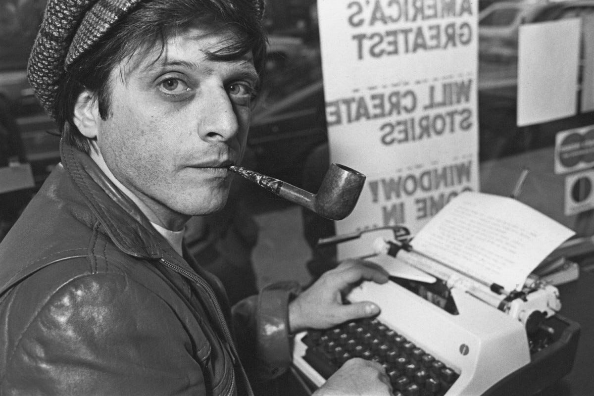 PROTOTYPE: Harlan Ellison in 1977 with his tools of the trade: a manual typewriter and tobacco pipe.