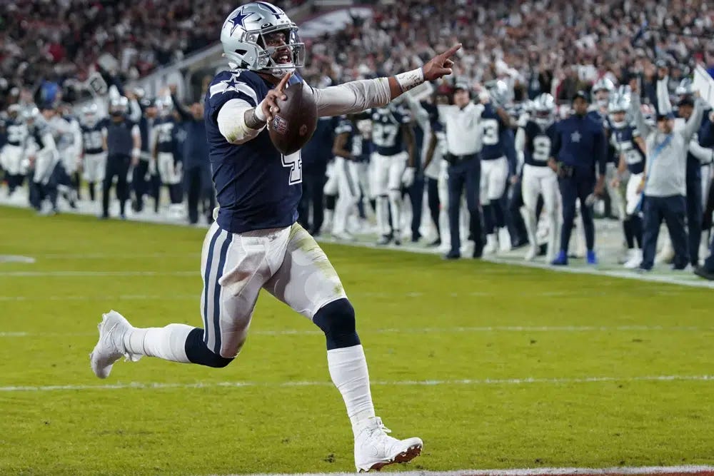 Dallas Cowboys quarterback Dak Prescott (4) runs into the end zone on a touchdown carry during the first half of an NFL wild-card football game against the Tampa Bay Buccaneers, Monday, Jan. 16, 2023, in Tampa, Fla. (AP Photo/John Raoux)