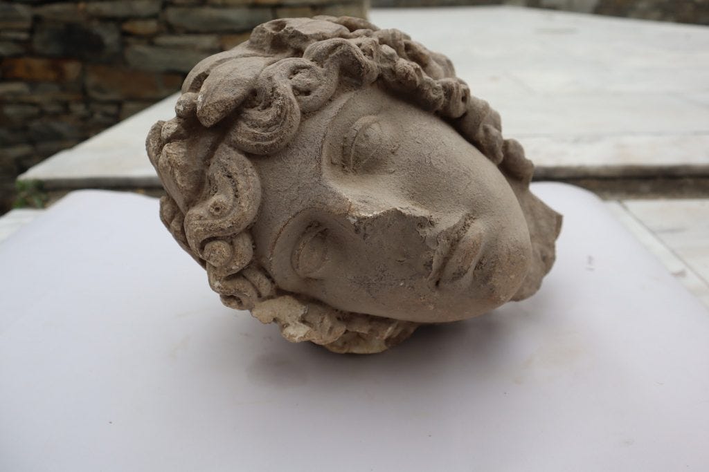 marble head of Apollo lying on surface