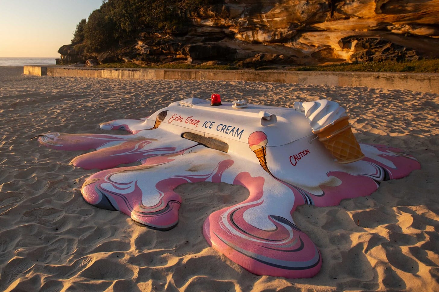 Ice cream truck melting into a beach sculpture by The Glue Society and James Dive.