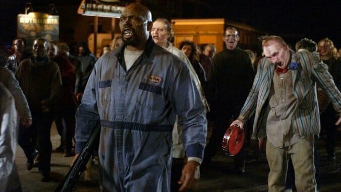 A large group of zombies in a street at night, led by Big Daddy, a Black zombie wearing coveralls. Behind him one of the zombies wears a barbershop costume and holds a tambourine. They are all walking in the same direction.