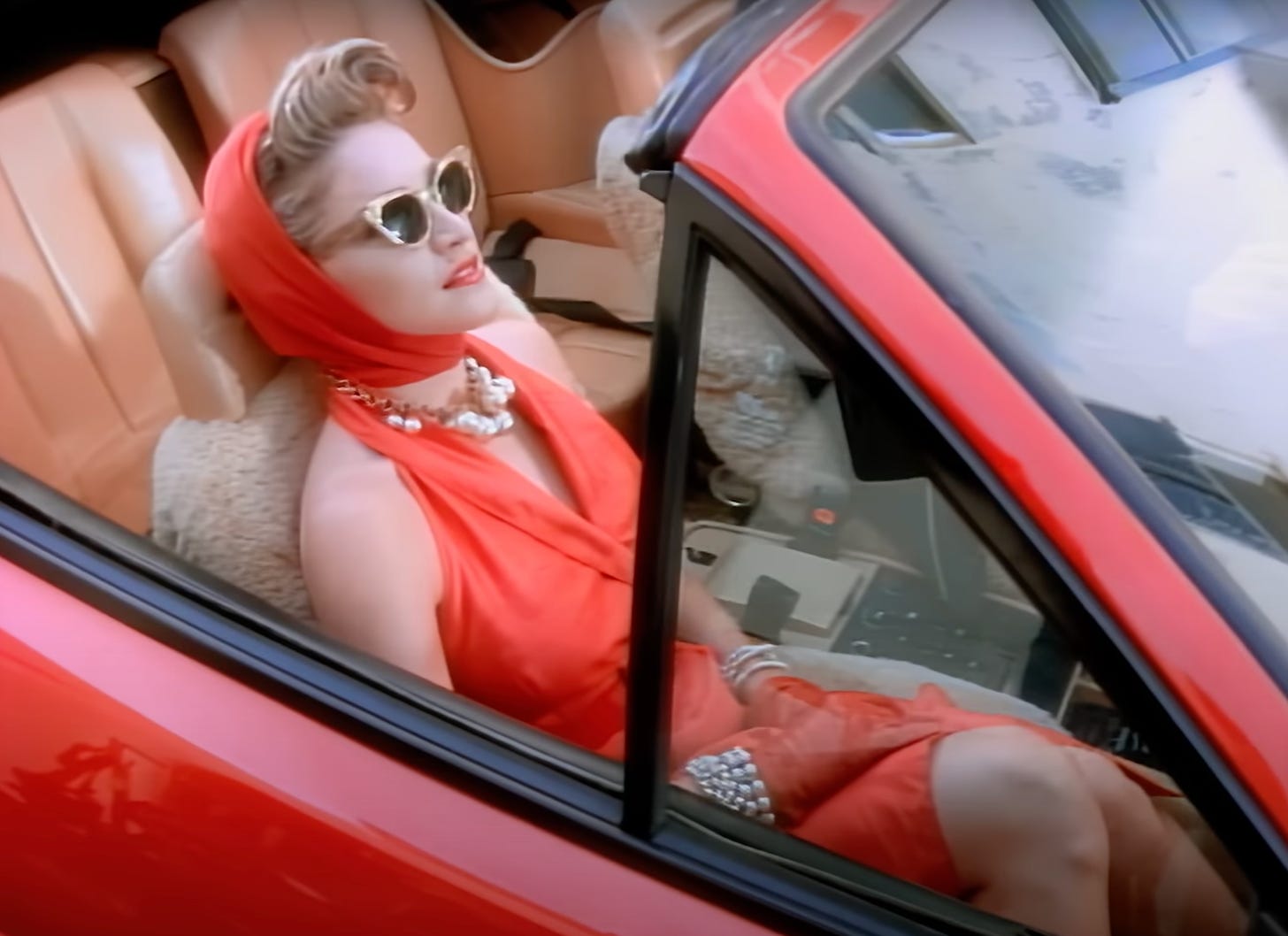 Madonna in a red sports car in the Material Girl video