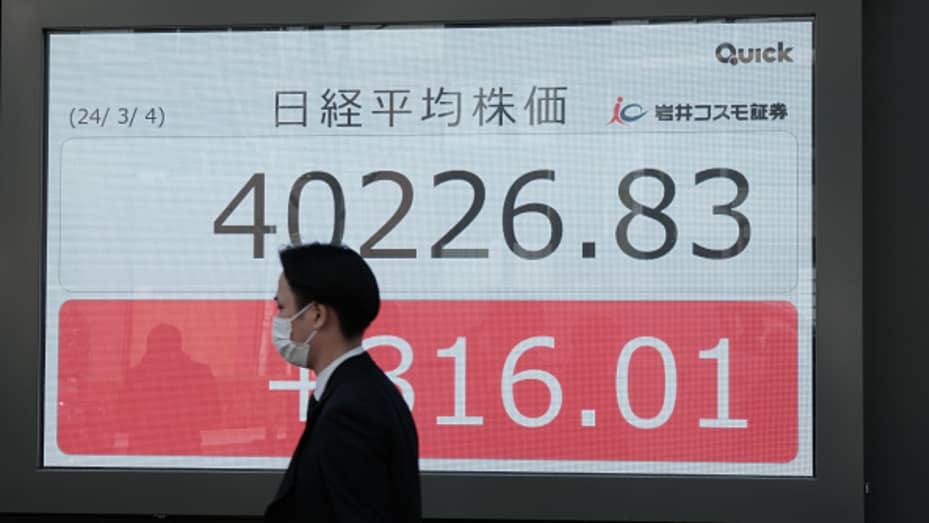 An electronic stock board displayed outside a securities firm in Tokyo, Japan, on Monday, March 4, 2024. Japan's Nikkei 225 Stock Average climbed above the psychological level of 40,000 for the first time, opening the door to further gains in its historic rally. Photographer: Soichiro Koriyama/Bloomberg via Getty Images