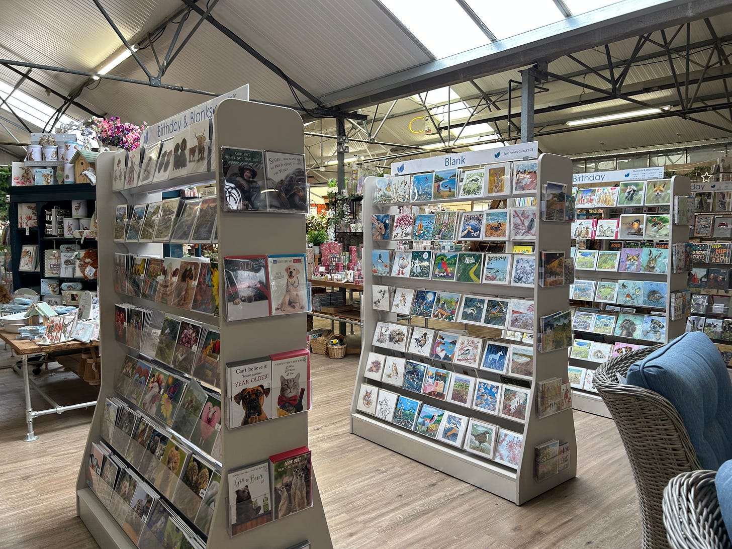 The gift section, Trowbridge Garden Centre. Greetings cards displayed on stands.