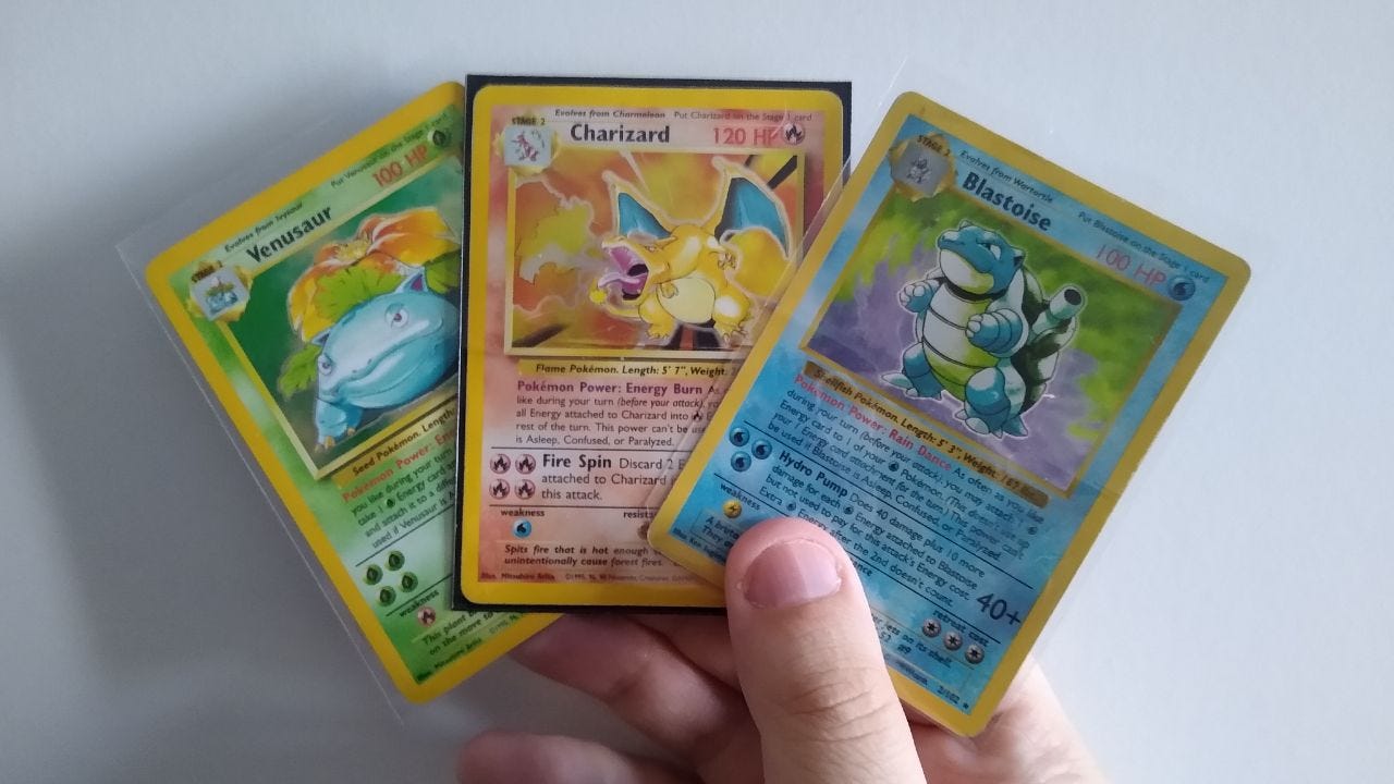 A picture of three base set Pokémon cards from my personal collection: Venusaur, Charizard and Blastoise