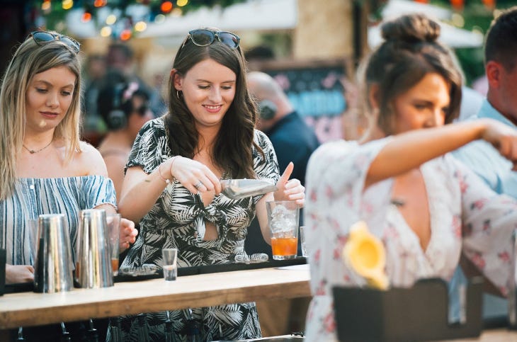 Three women mixing their own cocktails