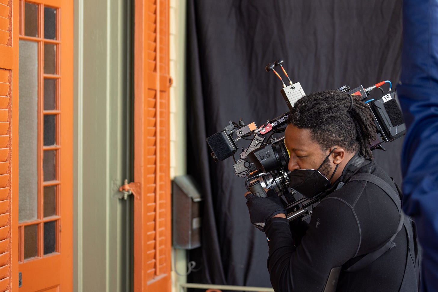 A photo of cinematographer Jomo Fray with the full camera set up