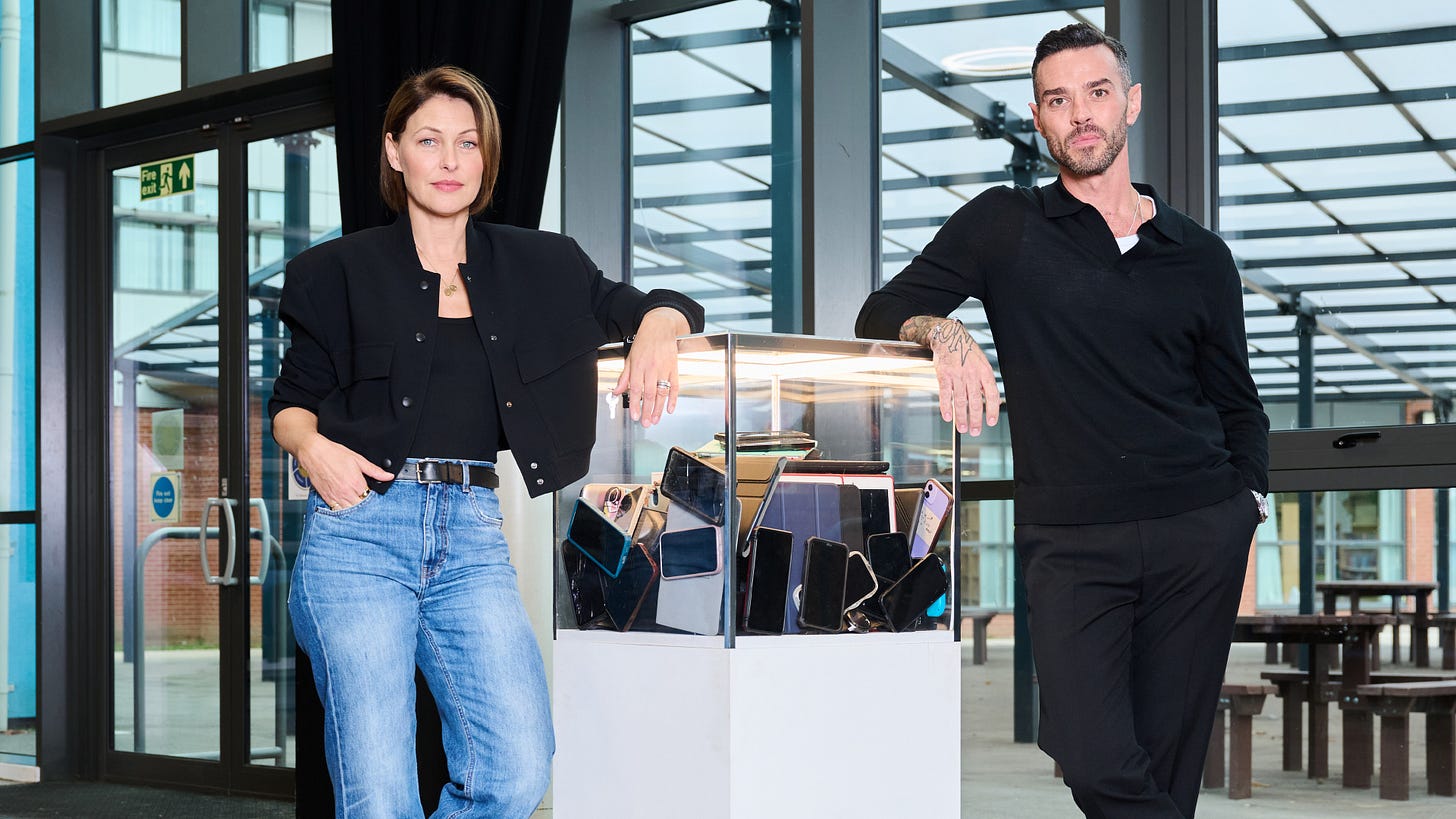 Emma and Matt Willis next to the glass box where all the social experiment participants' phones and iPads were locked into 