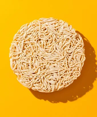 Ramen noodles on yellow background.