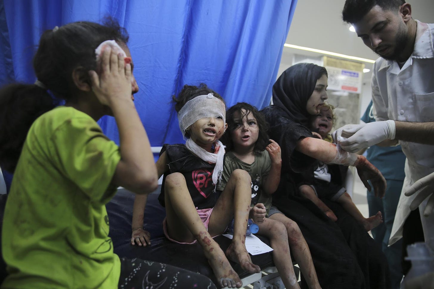Palestinian children wounded in Israeli strikes are brought to Shifa Hospital in Gaza City on Wednesday.