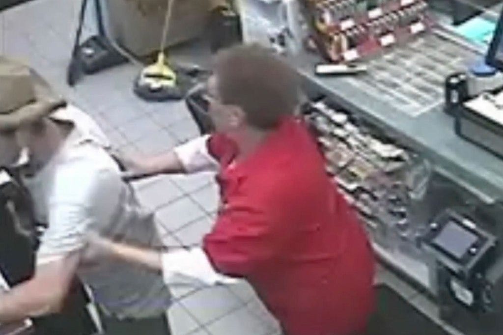 Moment clerk touches thief stealing cigarettes.