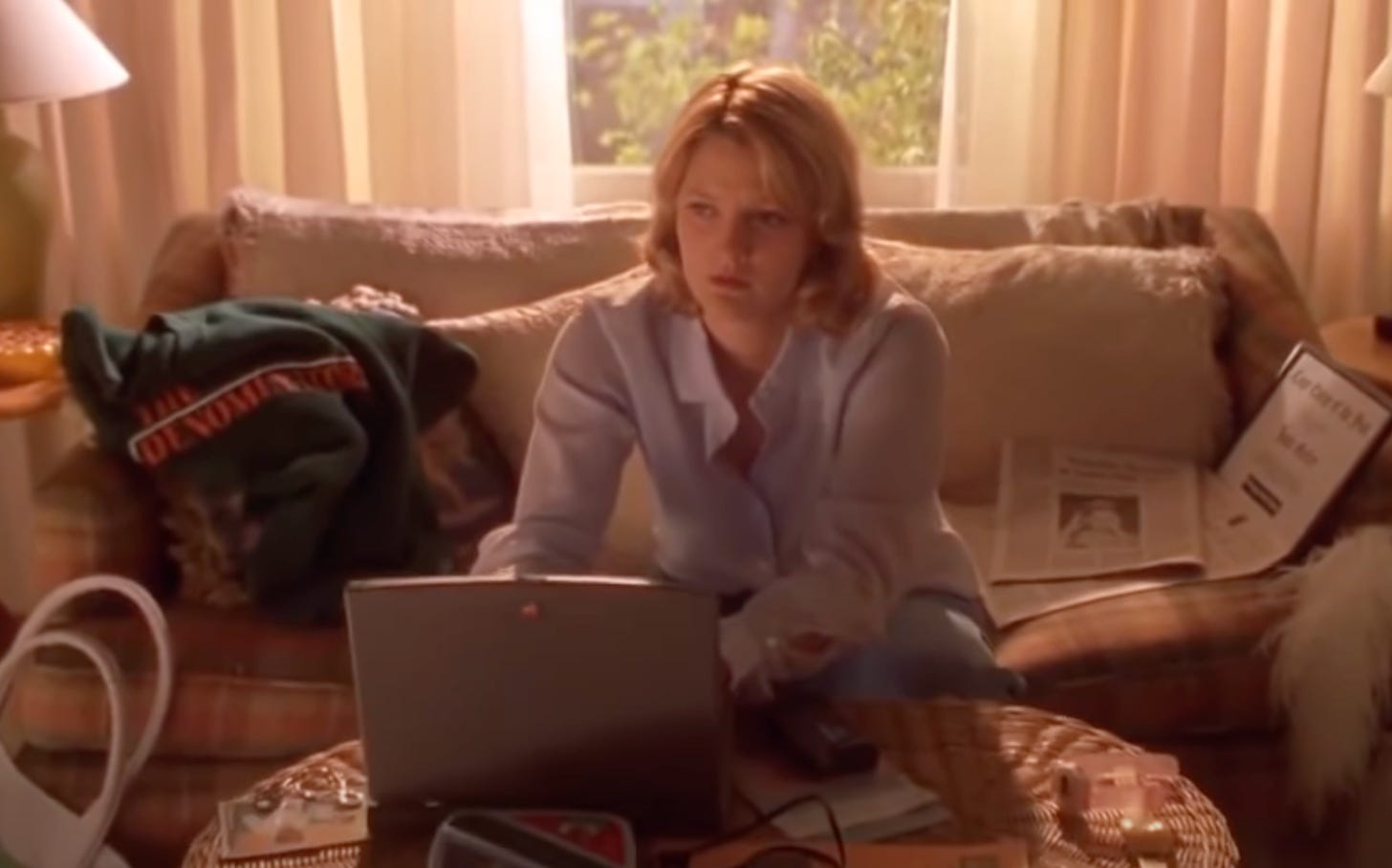 Drew Barrymore in Never Been Kissed sitting at laptop