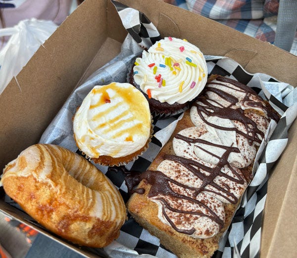 A box of cupcakes, donuts, and tiramisu