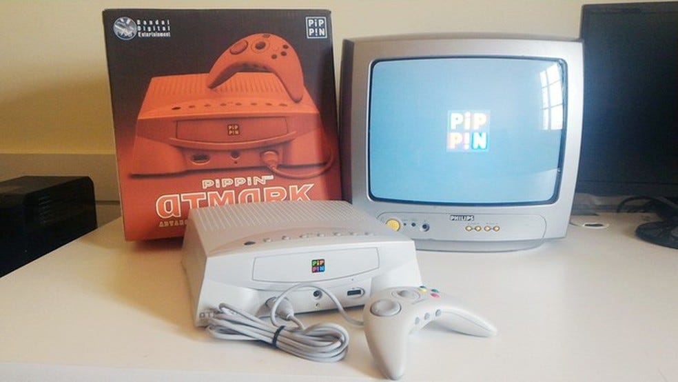 Apple-Bandai Pippin atmark, with original box, plugged into a small CRT television.