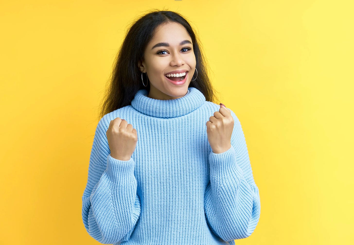 woman feeling happy successful on yellow background