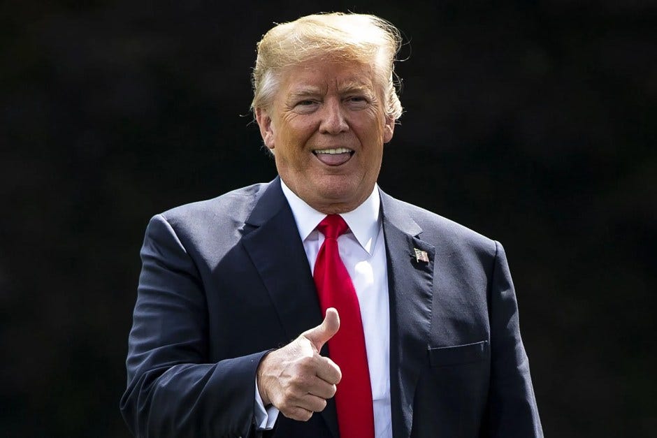 Donald Trump with his tongue sticking out like he's licking his lower lip, while giving a thumbs up