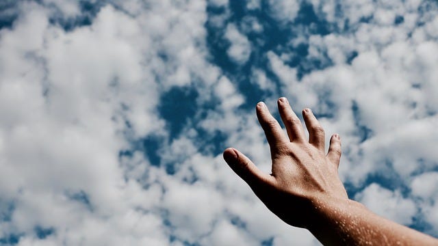 hand reaching up to the sky