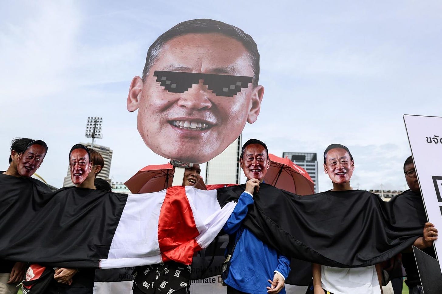 Protesters hold a placard depicting Prime Minister Srettha Thavisin during a rally in Bangkok on June 1. Bloomberg
