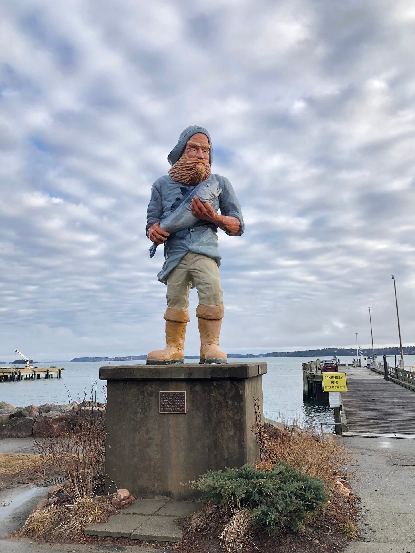 A 12-foot-tall statue of a fisher on the shoreline of Eastport, Maine