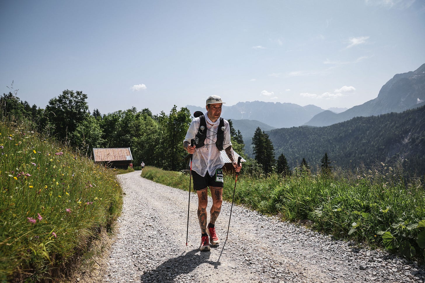 The author hiking up a dirt road in the heat
