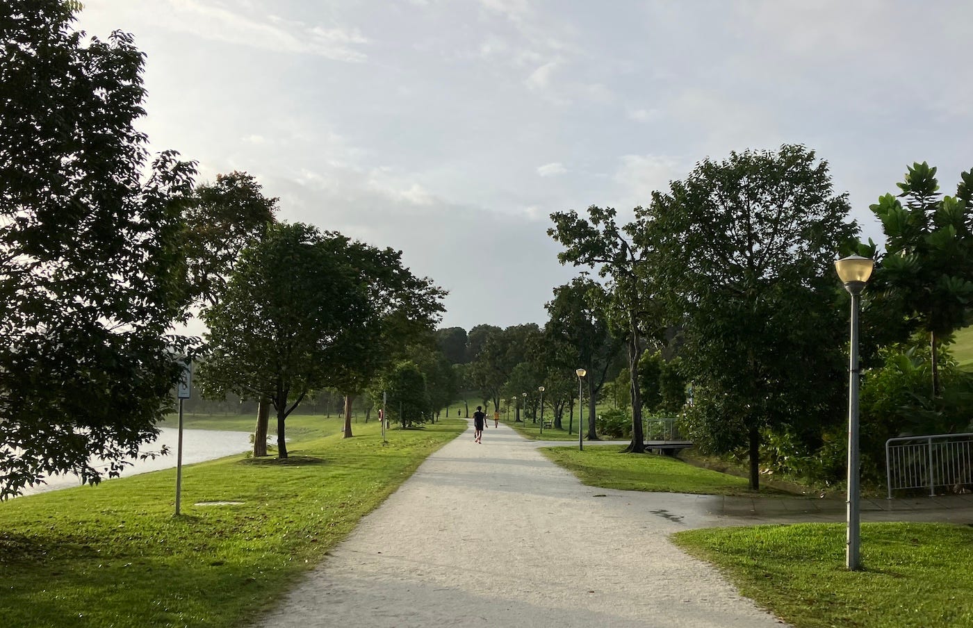 Runner on the path under cloudy skies