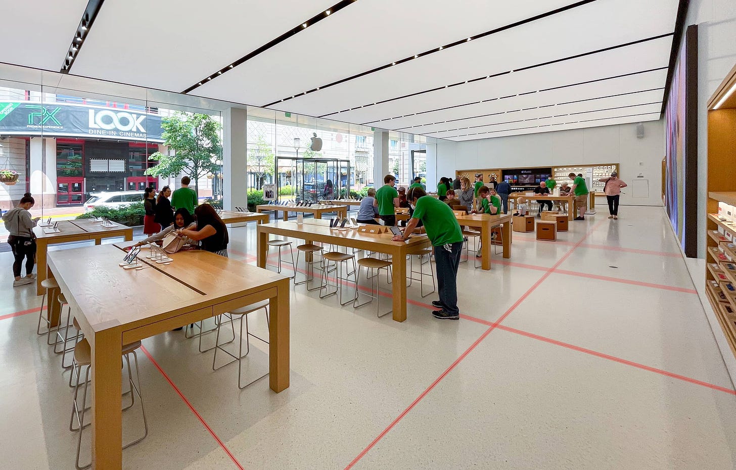 The interior of Apple Reston. Red lines superimposed over the floor highlight dividers in the terrazzo.
