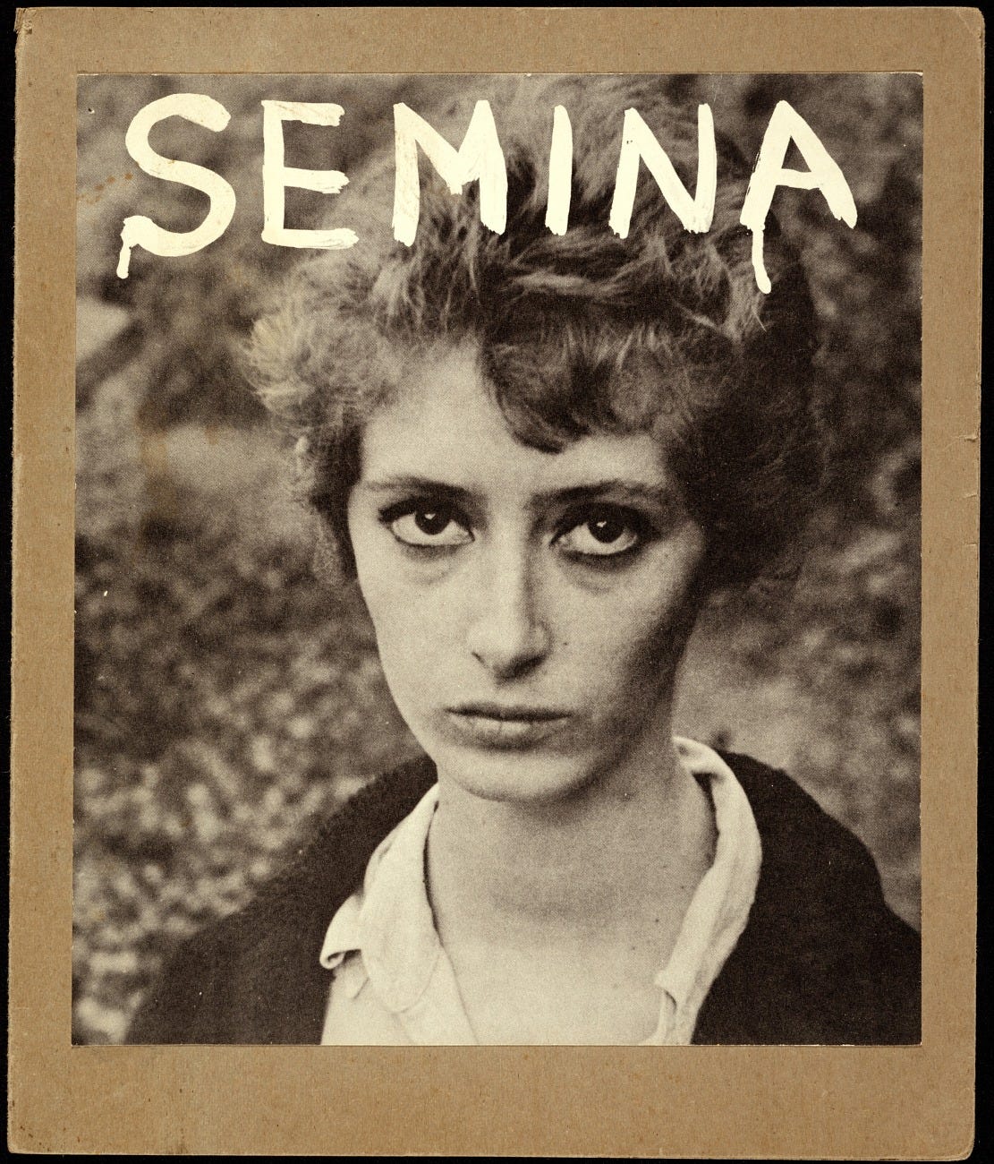 handprinted text semina on photograph of woman in black and white -- all mounted on cardboard