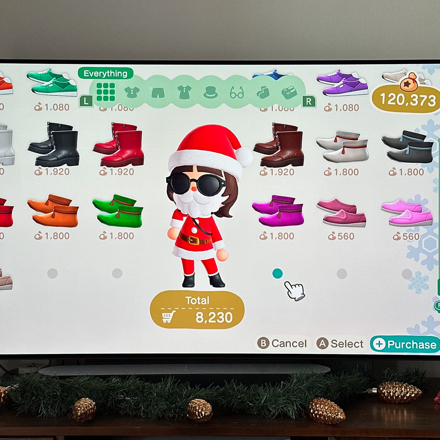 Photo of television set showing Animal Crossing New Horizons dressing room with character dressed as Santa
