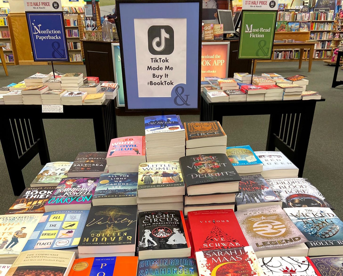 A table in a bookstore with a sign that says "TikTok made me buy it"