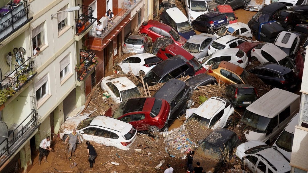 both photos in article shows cars piled up in brownish flood water in a city