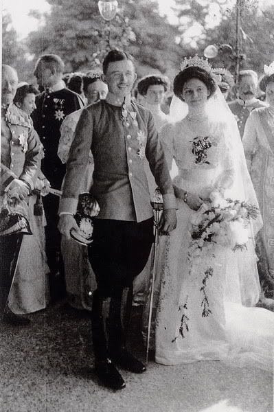 This may contain: an old black and white photo of a bride and groom walking down the aisle with their guests