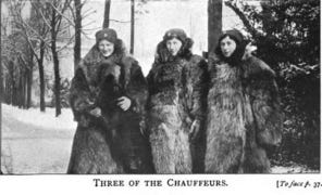 A black and white photograph with 3 women in their winter coats, walking in an alley at Royaumont during WWI, who were working there as ambulance drivers.