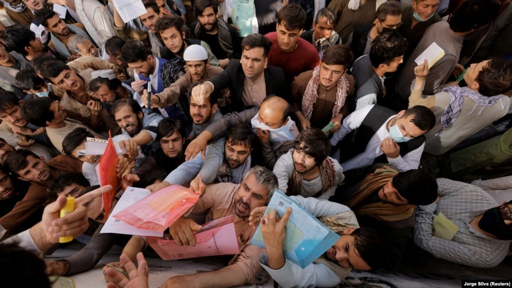 Afghans gather outside the passport office in Kabul in October 2021, two months after the Taliban seized power in Afghanistan. Hundreds of thousands of Afghans have fled the country since then.