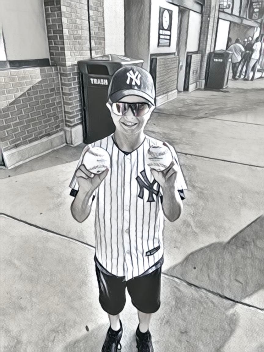 My son with two balls from batting practice