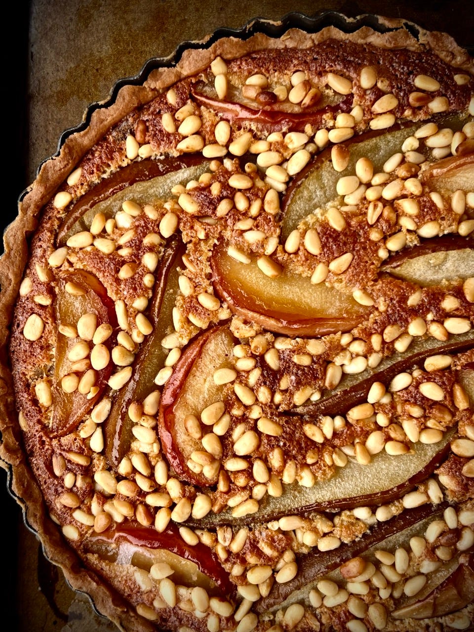 pear apple candied peel and pine nut tart in its case