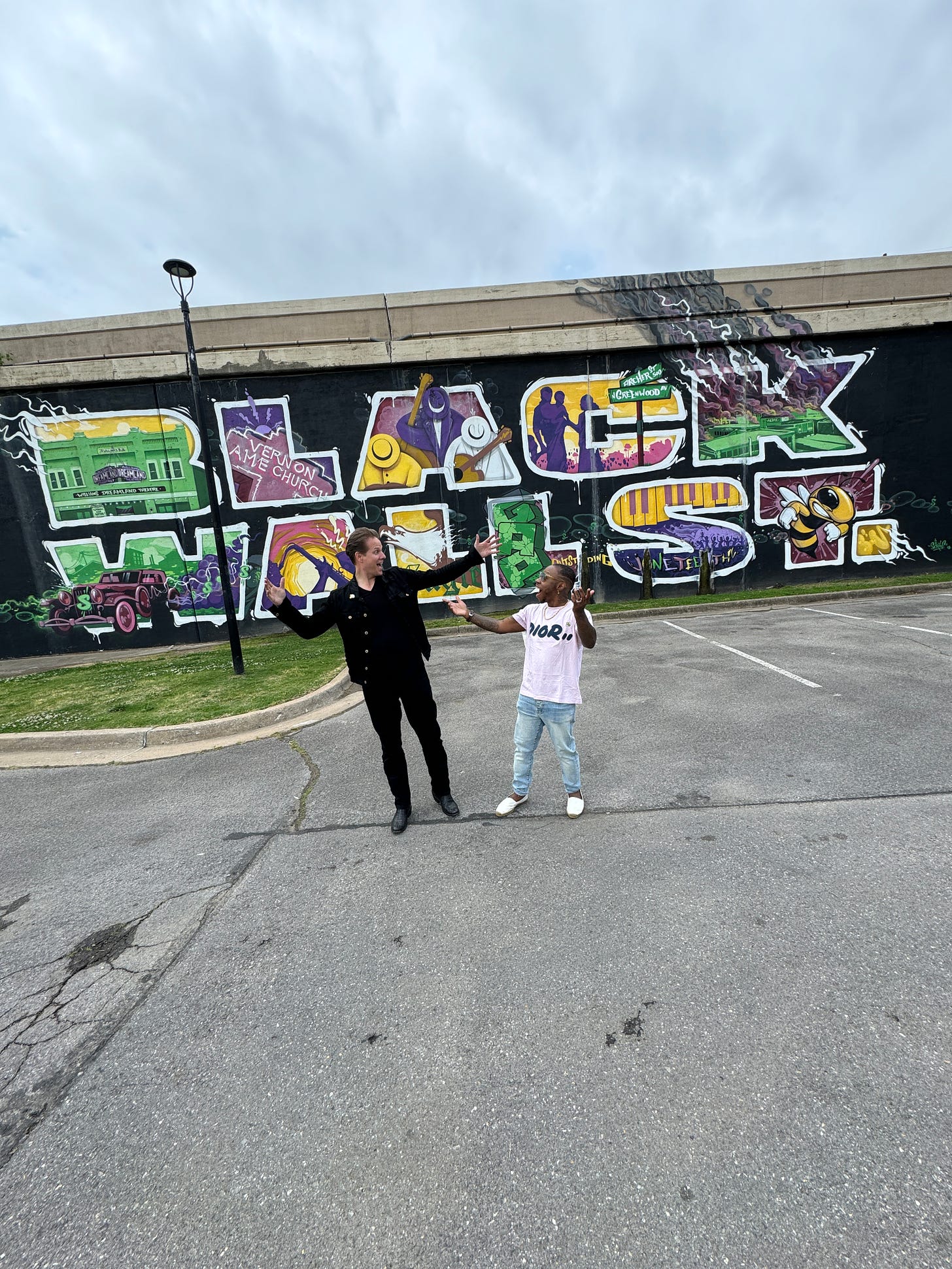 Jeremy and B. in front of Black Wall St wall in Tulsa, OK